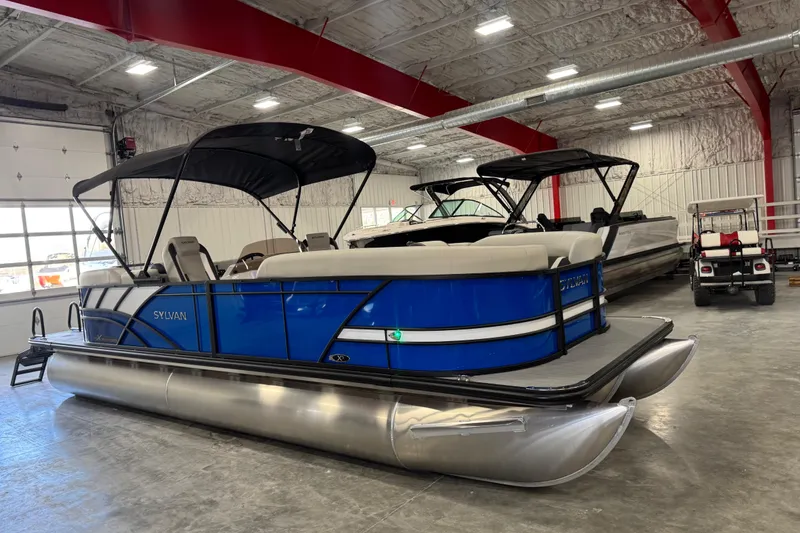Slide: The Image of 2026 Sylvan X5 pontoon boat with blue exterior in a showroom. - 15
