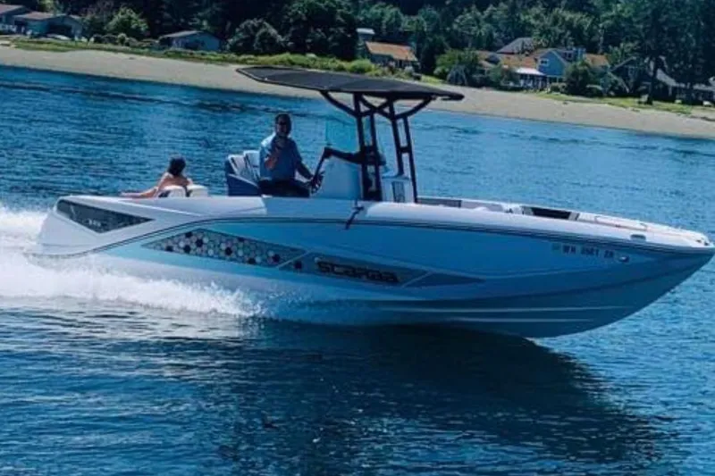Slide: The Image of 2018 Scarab 255 Open ID boat cruising on a sunny day near the shore. - 11