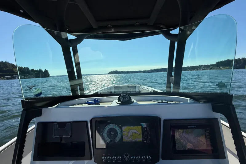 Slide: The Image of 2018 Scarab 255 Open ID boat dashboard view on a sunny day at sea. - 5