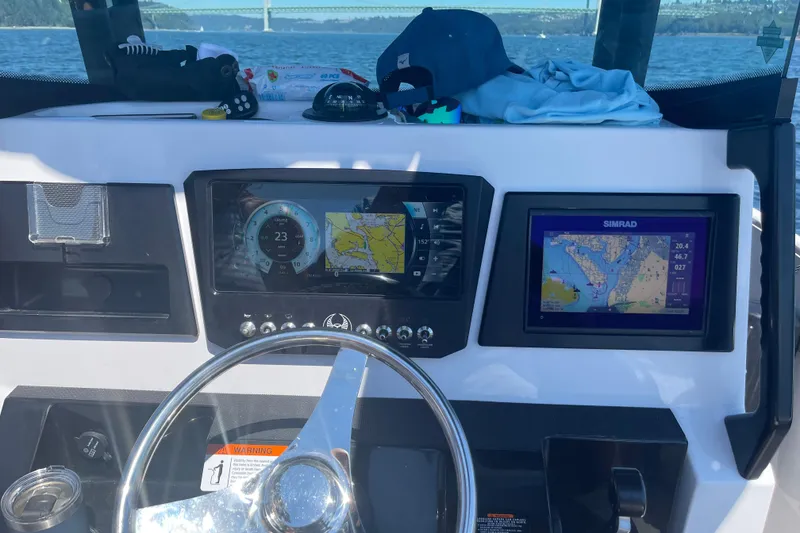 Slide: The Image of Dashboard of a 2018 Scarab 255 Open ID boat with navigation screens. - 8