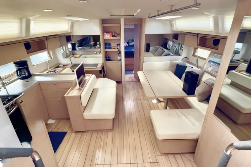 Slide: The Image of Interior of 2020 Beneteau Oceanis 51.1 yacht, featuring modern kitchen and dining area. - 3