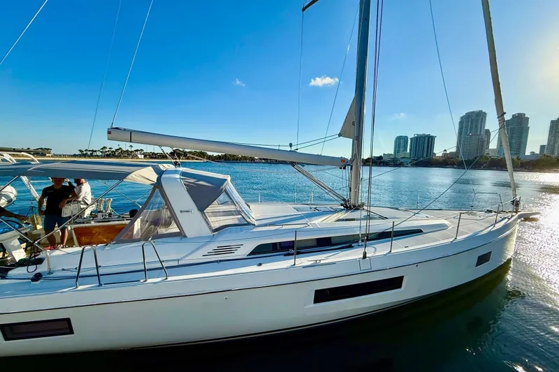 Slide: The Image of 2020 Beneteau Oceanis 51.1 sailboat docked with city skyline in background. - 30