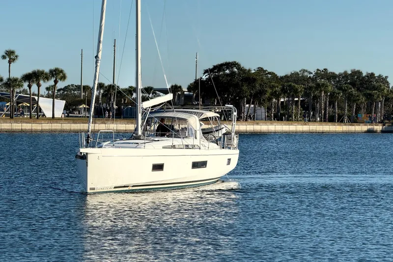 Slide: The Image of 2020 Beneteau Oceanis 51.1 sailing in calm waters near a palm-lined shore. - 31