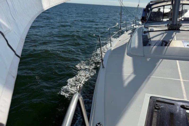 Slide: The Image of 2020 Beneteau Oceanis 51.1 sailing on open water, showcasing sleek deck design. - 33