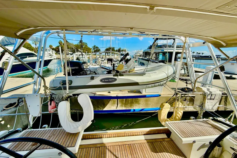 Slide: The Image of Beneteau Oceanis 51.1 yacht docked with inflatable boat, 2020 model, marina view. - 35