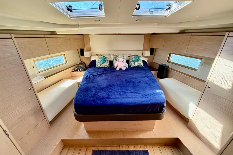 Slide: The Image of Luxurious cabin interior of 2020 Beneteau Oceanis 51.1 yacht with plush bedding. - 4