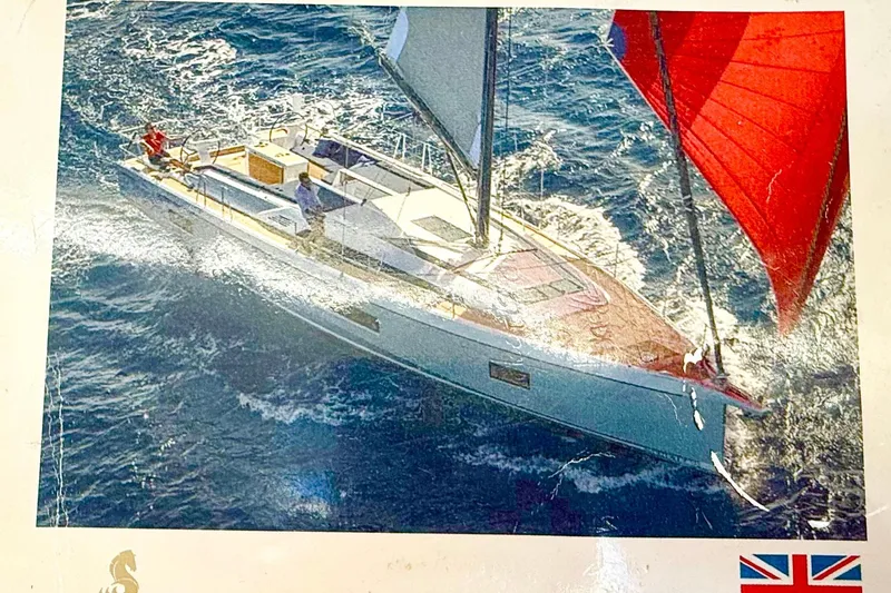 Slide: The Image of 2020 Beneteau Oceanis 51.1 sailing yacht with red sails on open sea, aerial view. - 44