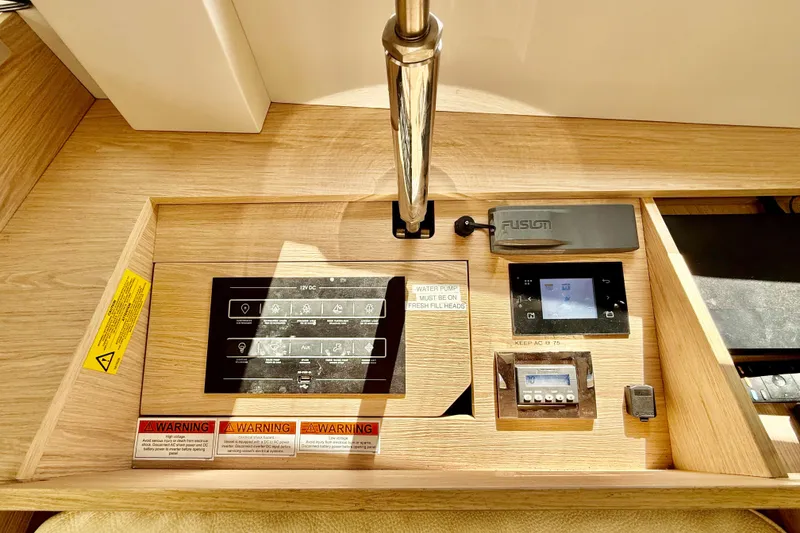 Slide: The Image of Control panel of a 2020 Beneteau Oceanis 51.1 yacht with various switches and displays. - 45