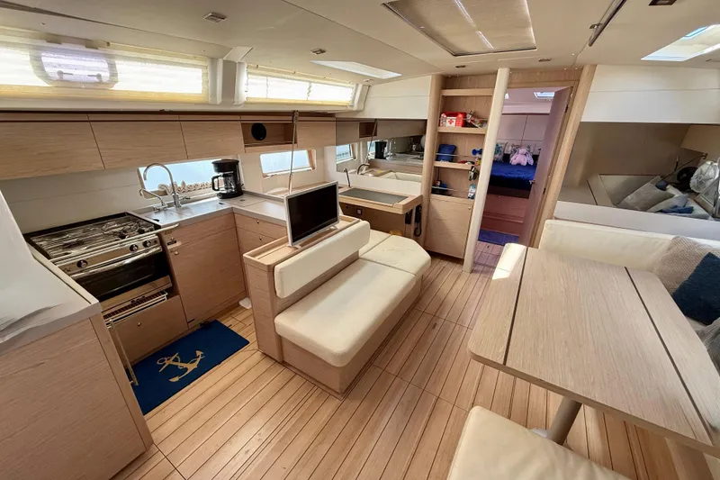 Slide: The Image of Luxurious interior of 2020 Beneteau Oceanis 51.1 yacht with modern kitchen and seating area. - 47