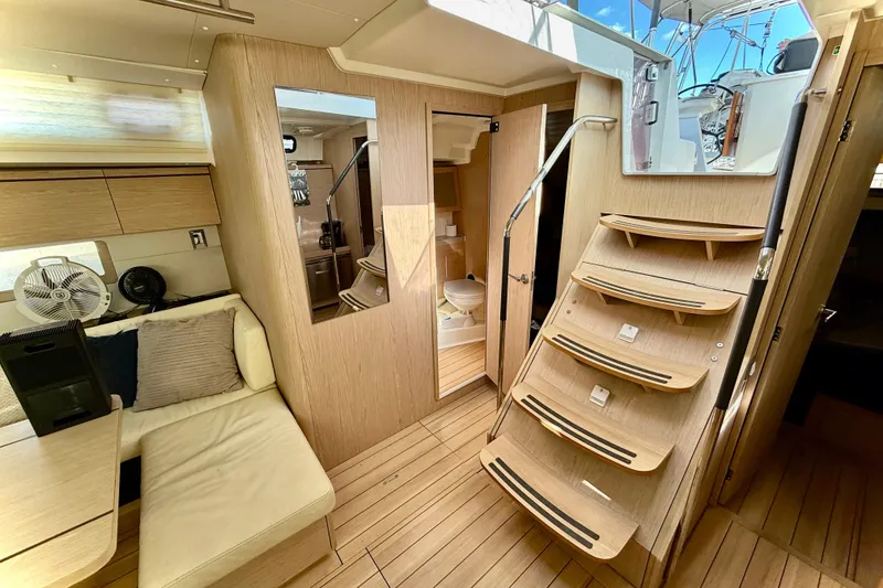 Slide: The Image of Interior of 2020 Beneteau Oceanis 51.1 yacht, featuring modern wood finish and cozy seating. - 50