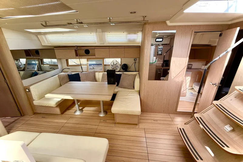 Slide: The Image of Luxurious interior of 2020 Beneteau Oceanis 51.1 yacht with modern seating and wooden finishes. - 52