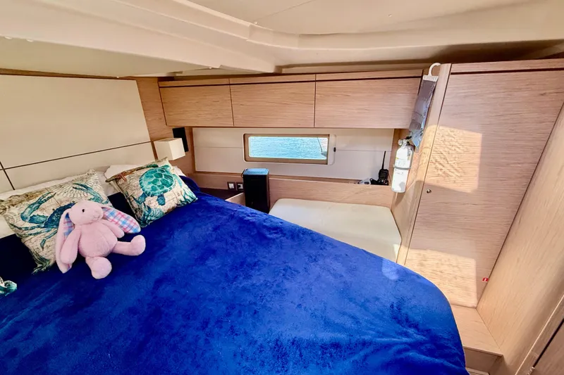 Slide: The Image of Luxurious cabin interior of 2020 Beneteau Oceanis 51.1 yacht with plush bedding and wooden cabinetry. - 65