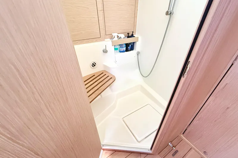 Slide: The Image of Beneteau Oceanis 51.1 2020 yacht shower with wooden seat and modern fixtures. - 66