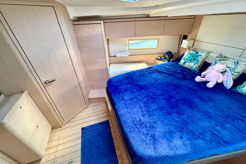 Slide: The Image of Luxurious cabin interior of 2020 Beneteau Oceanis 51.1 with plush bedding and nautical decor. - 68