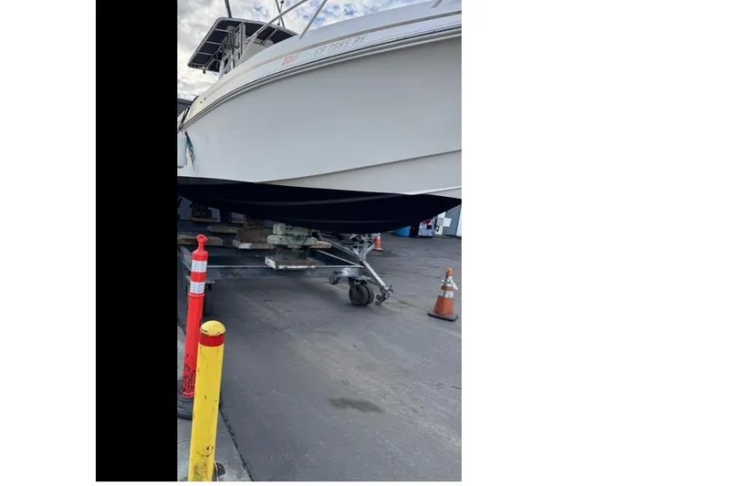 Slide: The Image of 2004 Fountain 31 Tournament Edition boat on trailer in a parking area. - 12