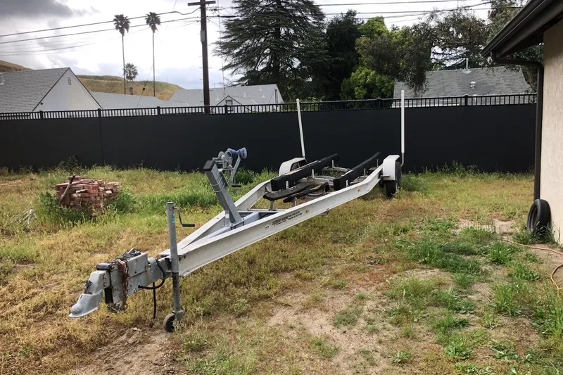 Slide: The Image of Trailer for 2004 Fountain 31 Tournament Edition boat in grassy yard. - 16