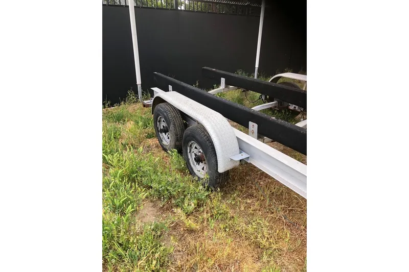 Slide: The Image of Trailer for 2004 Fountain 31 Tournament Edition boat, parked on grassy area. - 17