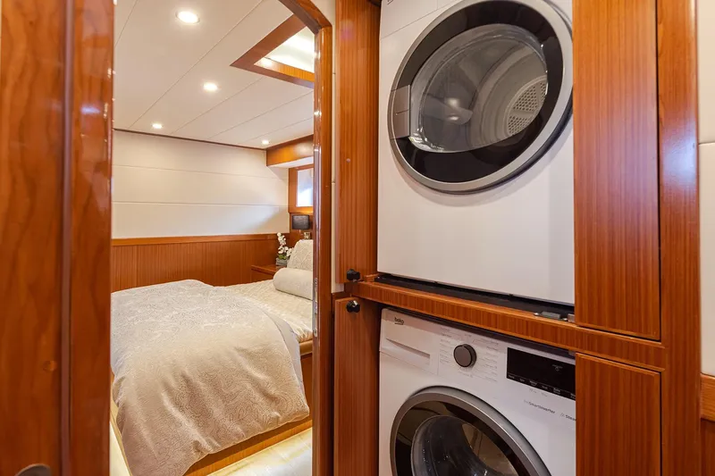 Slide: The Image of Luxurious Apollonian Yachts 52 Pilothouse interior with bedroom and laundry area, 2025 model. - 17