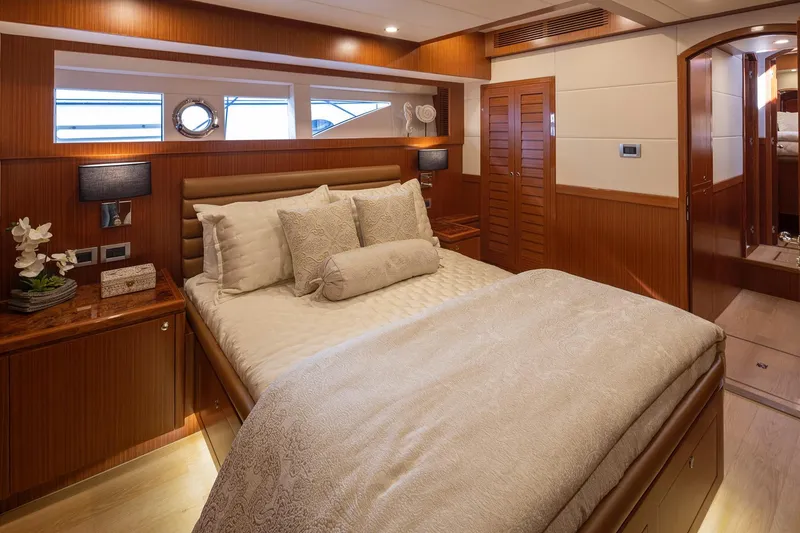 Slide: The Image of Luxurious bedroom interior of 2025 Apollonian Yachts 52 Pilothouse, featuring elegant wood finishes. - 18