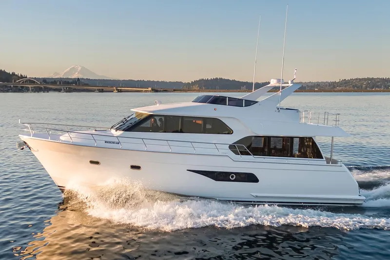 Slide: The Image of 2025 Apollonian Yachts 52 Pilothouse cruising on serene waters at sunset. - 3