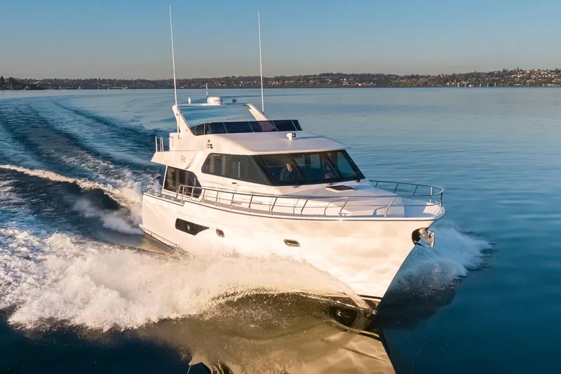 Slide: The Image of 2025 Apollonian Yachts 52 Pilothouse cruising on calm waters at sunset. - 4