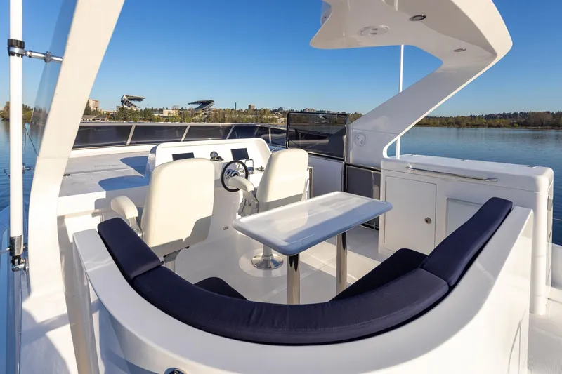 Slide: The Image of Luxurious 2025 Apollonian Yachts 52 Pilothouse with elegant outdoor seating and scenic water view. - 5