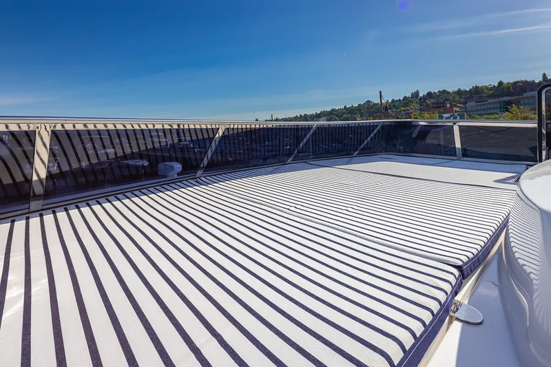 Slide: The Image of Luxurious deck of 2025 Apollonian Yachts 52 Pilothouse with striped sunbathing area. - 7