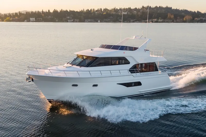 Slide: The Image of Luxury 2025 Apollonian Yachts 52 Pilothouse cruising on serene waters. - 2