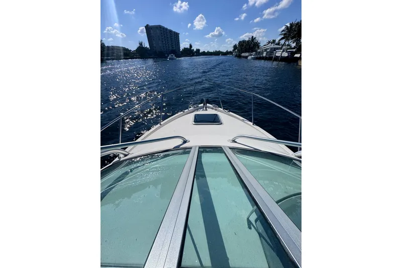 Slide: The Image of 2014 Robalo R265 Walkaround cruising on a sunny waterway with scenic views. - 12