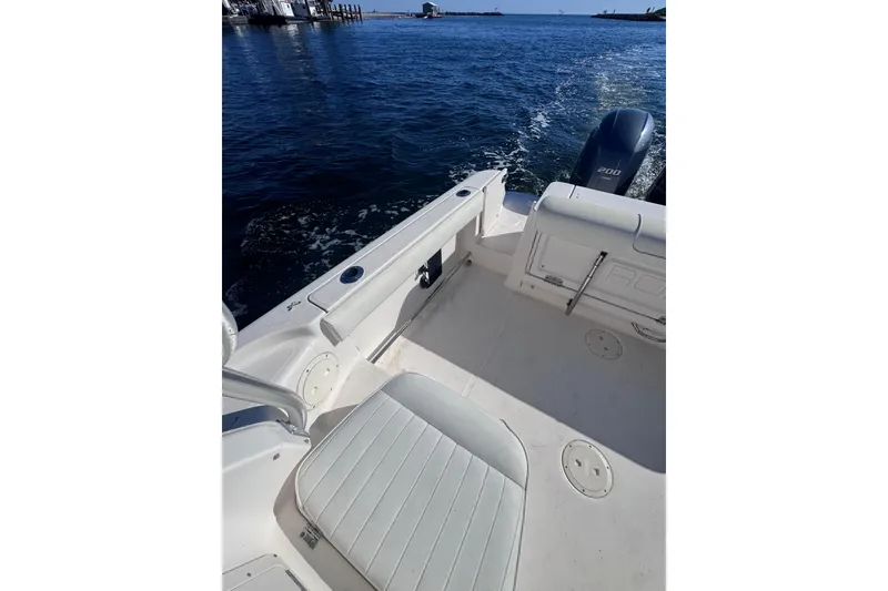 Slide: The Image of 2014 Robalo R265 Walkaround boat interior with Yamaha 200 engine on open water. - 16