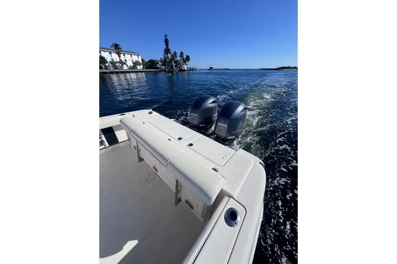Slide: The Image of 2014 Robalo R265 Walkaround boat cruising on a sunny day with twin engines. - 18
