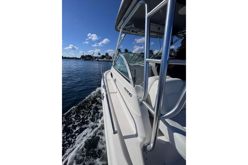 Slide: The Image of 2014 Robalo R265 Walkaround boat cruising on a sunny day with clear skies. - 24