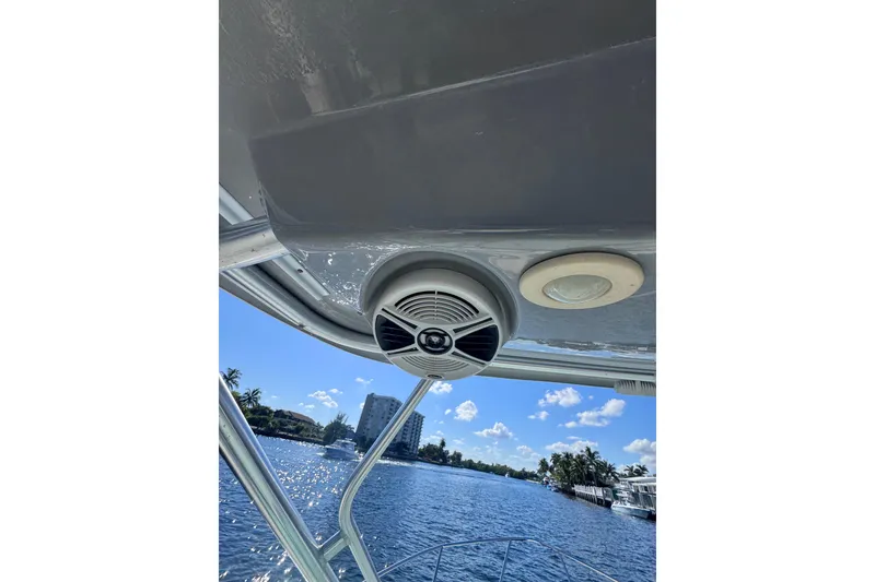 Slide: The Image of 2014 Robalo R265 Walkaround boat with speaker and light, scenic water view. - 29
