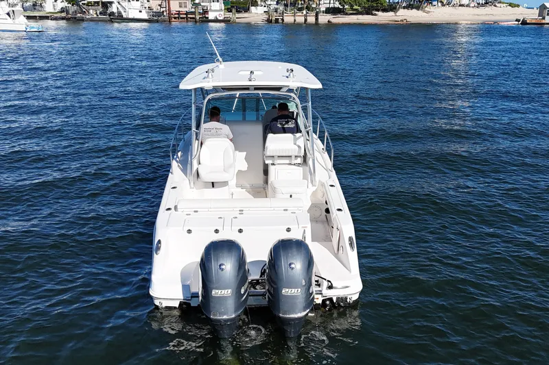 Slide: The Image of 2014 Robalo R265 Walkaround boat with dual engines on open water. - 3