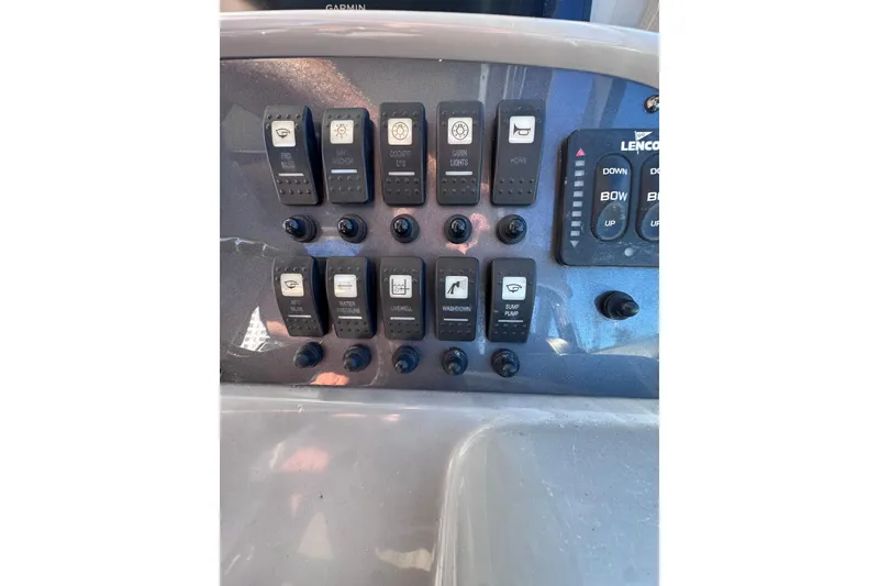 Slide: The Image of Control panel of 2014 Robalo R265 Walkaround boat with labeled switches and buttons. - 31