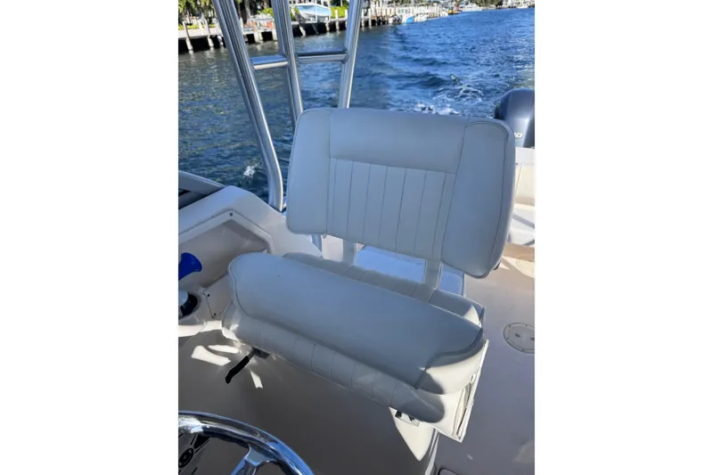 Slide: The Image of 2014 Robalo R265 Walkaround boat seat with ocean view in background. - 36