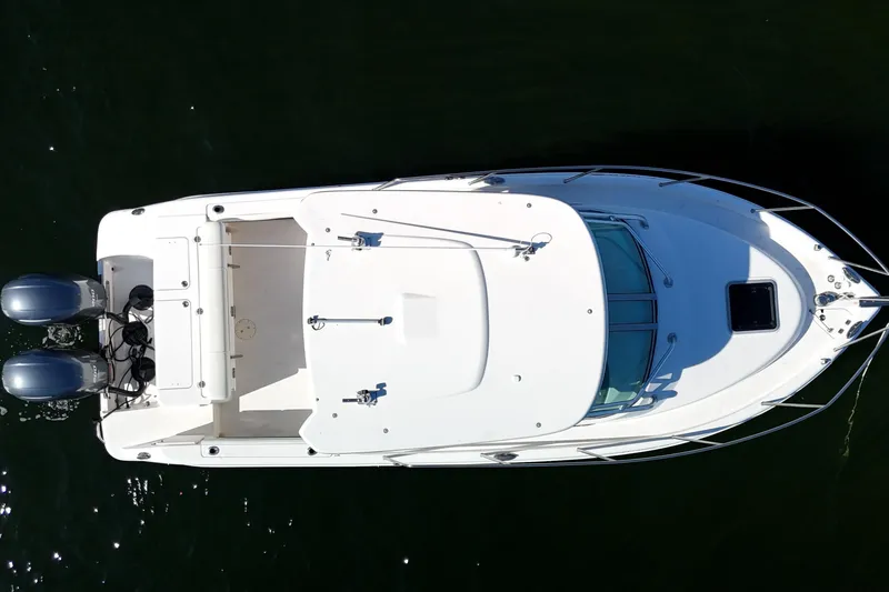 Slide: The Image of Top view of 2014 Robalo R265 Walkaround boat with dual engines on water. - 9
