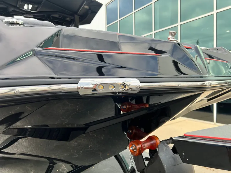 Slide: The Image of 2026 Tigé 24RZX boat detail, sleek black design with chrome accents and LED lights. - 10