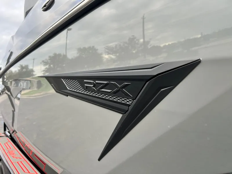 Slide: The Image of Close-up of 2026 Tigé 24RZX boat emblem on sleek exterior. - 11