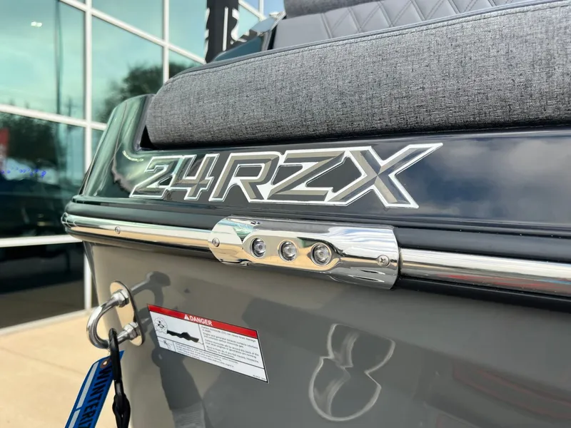 Slide: The Image of 2026 Tigé 24RZX boat rear view with logo and warning label. - 14