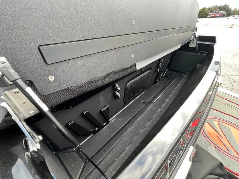 Slide: The Image of 2026 Tigé 24RZX boat storage compartment with open lid, showcasing interior details. - 15