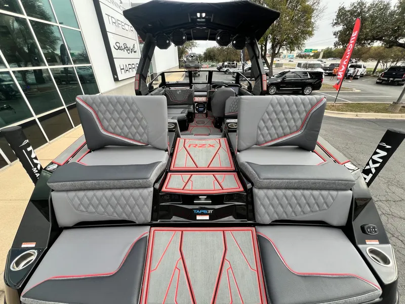 Slide: The Image of 2026 Tigé 24RZX boat interior with gray and red seating, showcasing luxury design. - 17
