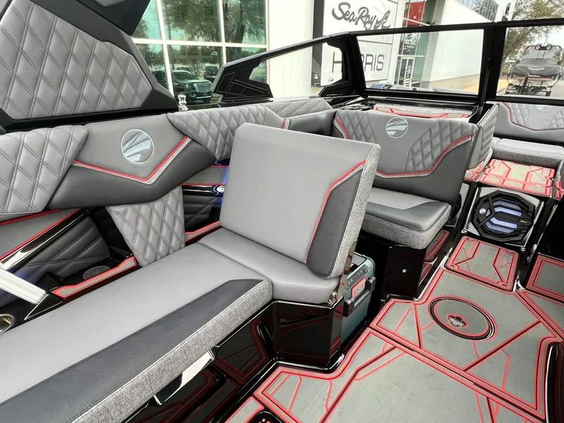 Slide: The Image of Luxurious interior of 2026 Tigé 24RZX boat with gray and red accents. - 24