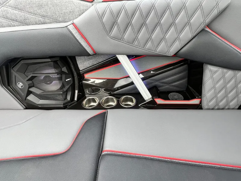 Slide: The Image of 2026 Tigé 24RZX interior with premium speaker, quilted upholstery, and cup holders. - 26