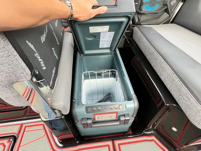 Slide: The Image of Open cooler compartment in 2026 Tigé 24RZX boat interior. - 29
