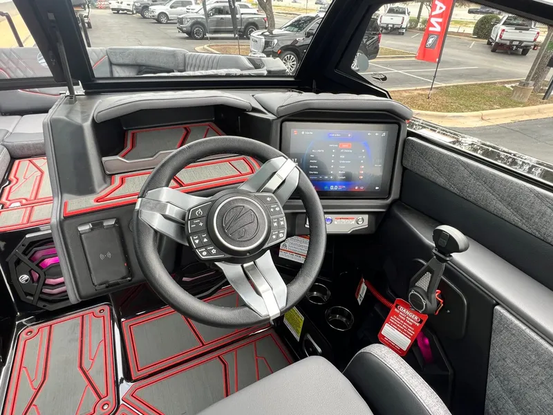 Slide: The Image of 2026 Tigé 24RZX boat interior with modern steering wheel and touchscreen display. - 32