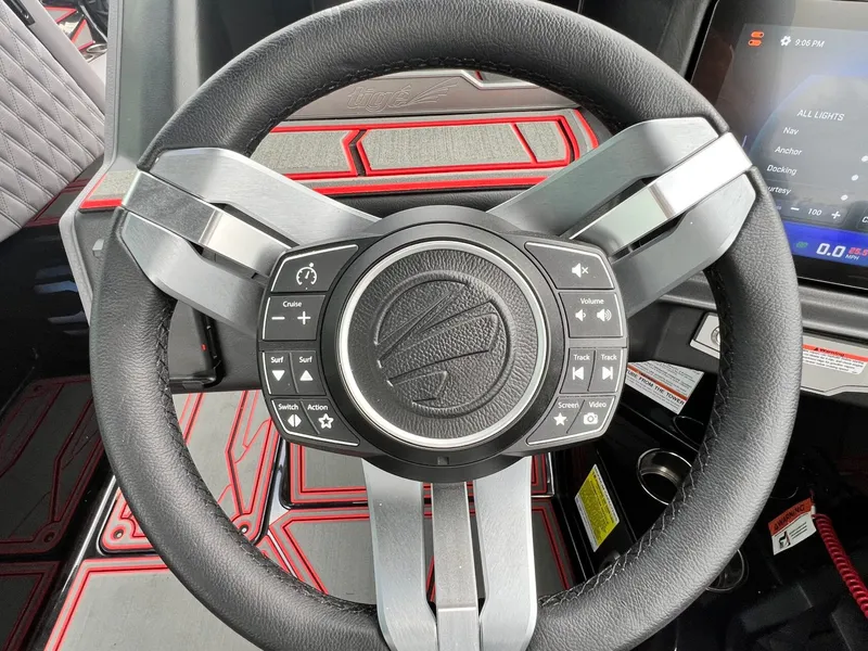 Slide: The Image of Steering wheel of 2026 Tigé 24RZX boat with control buttons and display. - 33