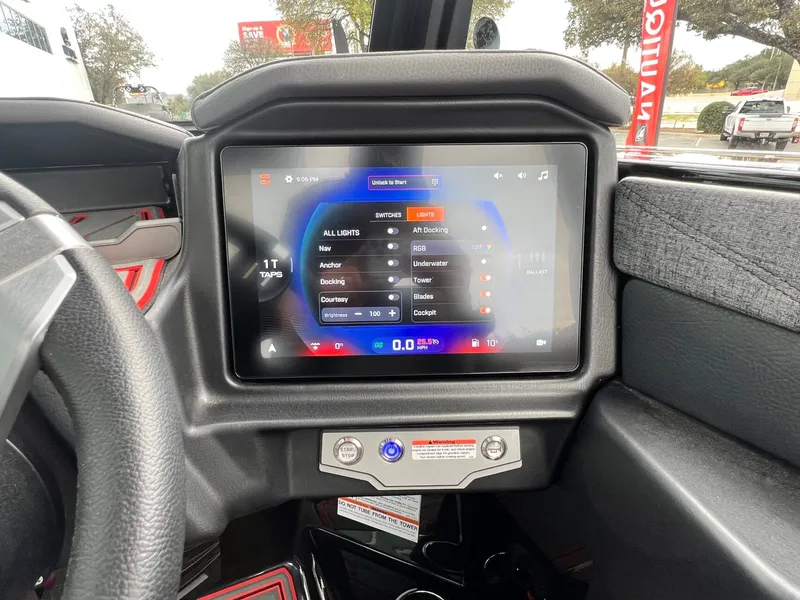 Slide: The Image of 2026 Tigé 24RZX dashboard with touchscreen controls for lights and navigation. - 34