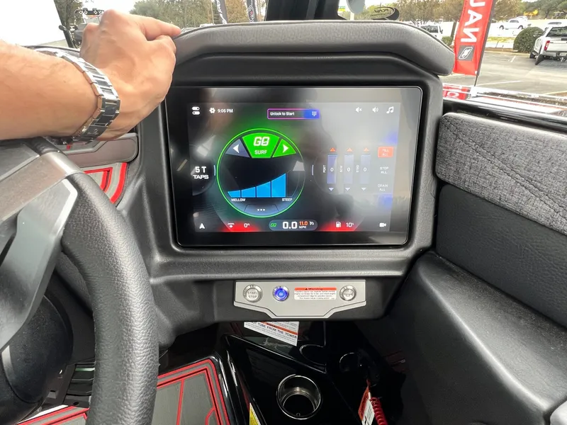 Slide: The Image of 2026 Tigé 24RZX dashboard with touchscreen display showing surf settings and controls. - 36