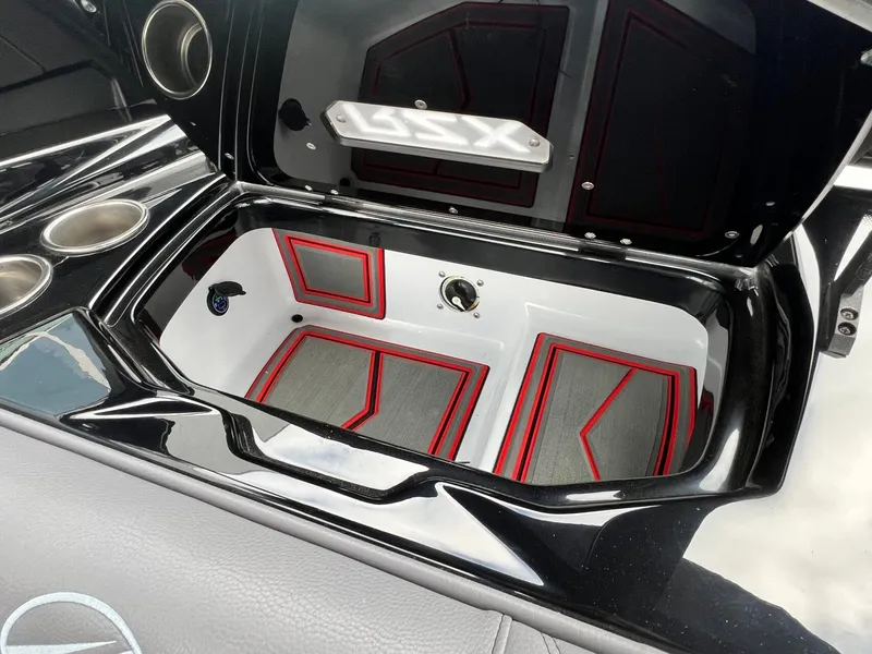 Slide: The Image of 2026 Tigé 24RZX boat storage compartment with sleek black and red interior design. - 39